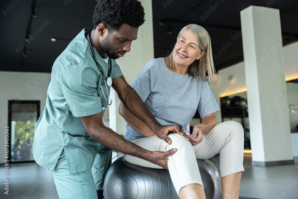 African american manual therapist working with a female patient with problematic joints African american manual therapist working with a female patient with problematic joints
