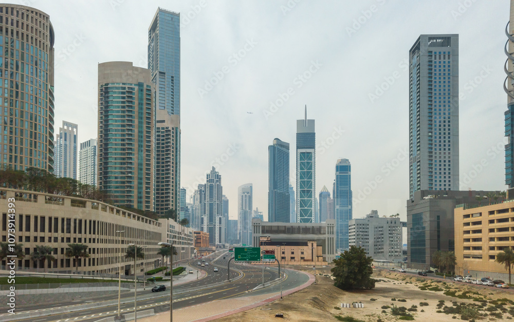 Modern skyscrapers in Downtown Dubai with a wide urban road, creating a captivating cityscape. Modern skyscrapers in Downtown Dubai with a wide urban road, creating a captivating cityscape.