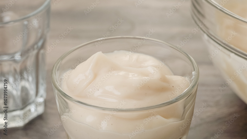 Serving white chocolate vanilla bean pudding in a glass. Perfect deliciously dessert Serving white chocolate vanilla bean pudding in a glass. Perfect deliciously dessert