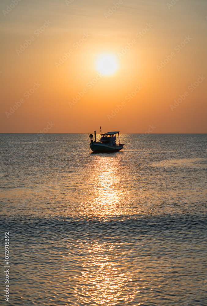 A fishing boat on the water under the setting sun, reflected in the calm ocean waves. The warm sunset colors add romance and tranquility to the scene A fishing boat on the water under the setting sun, reflected in the calm ocean waves. The warm sunset colors add romance and tranquility to the scene