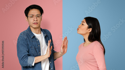 Autism And Relationships Concept. Concerned Autistic Guy Rejecting Kisses From His Girlfriend, Avoiding Physical Contact, Light Background photo