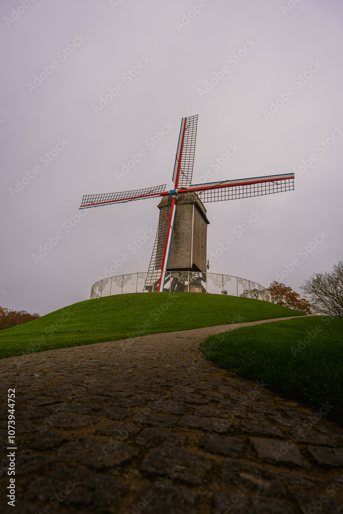Obraz premium Belgium windmill in Bruges, Belgium. Colourful windmill.