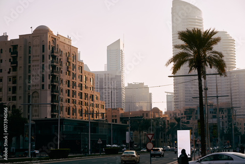 Traditional beige buildings in Dubai’s historic district with modern skyscrapers in the background, blending old and new architecture photo