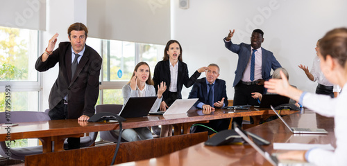Bild auf Leinwand Irritated multiethnic various aged business team arguing to each other on corpor