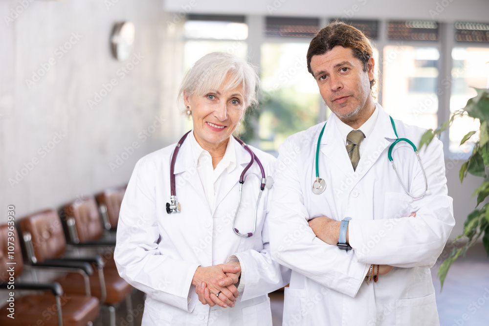 Portrait of two doctors at the office of medical clinic Portrait of two doctors at the office of medical clinic