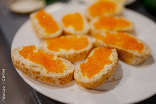 Orange caviar on white bread with butter. Slavic and Baltic typical cuisine for breakfast in the weekend