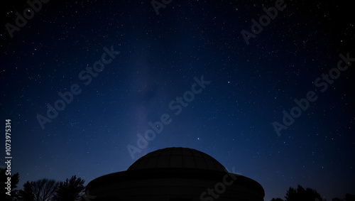 A night sky filled with stars over a large observatory dome, perfect for astronomy and space exploration themes. photo