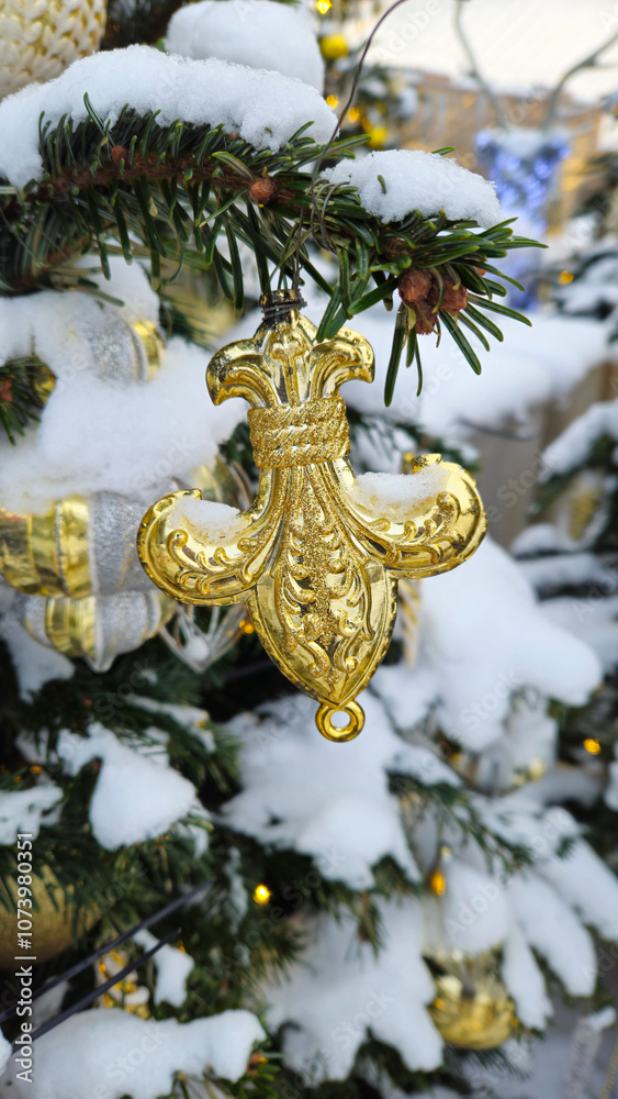 Fototapeta premium Branches of Christmas tree with beautiful decoration covered with snow