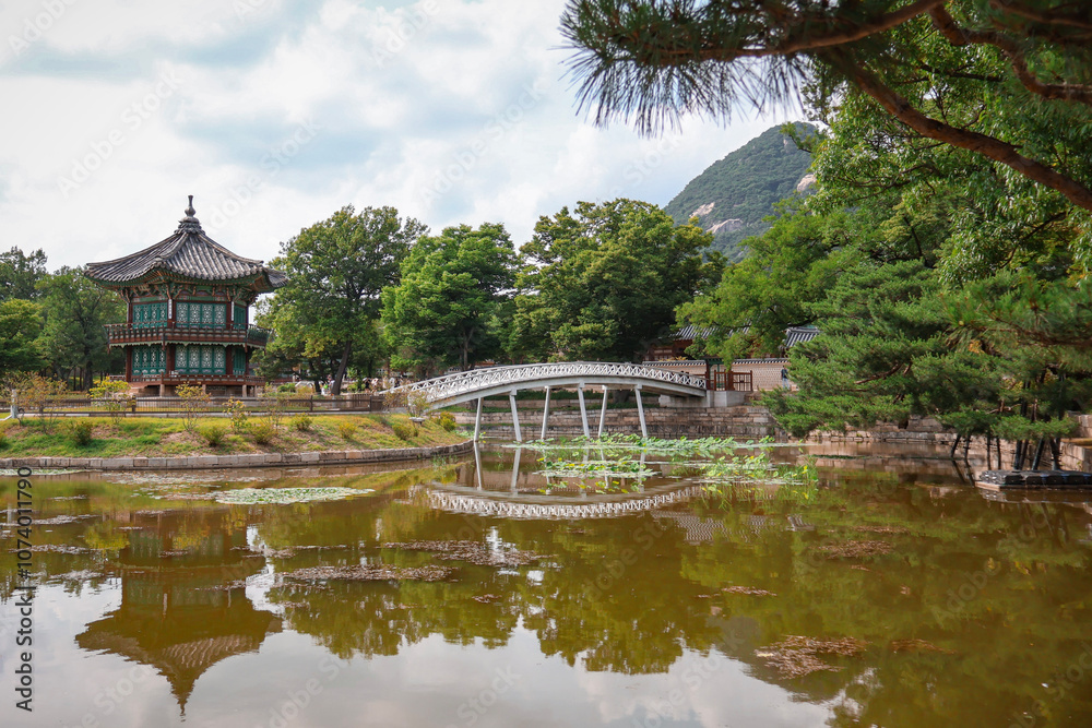 Asian garden in spring, water and bridge leading to small temple Asian garden in spring, water and bridge leading to small temple