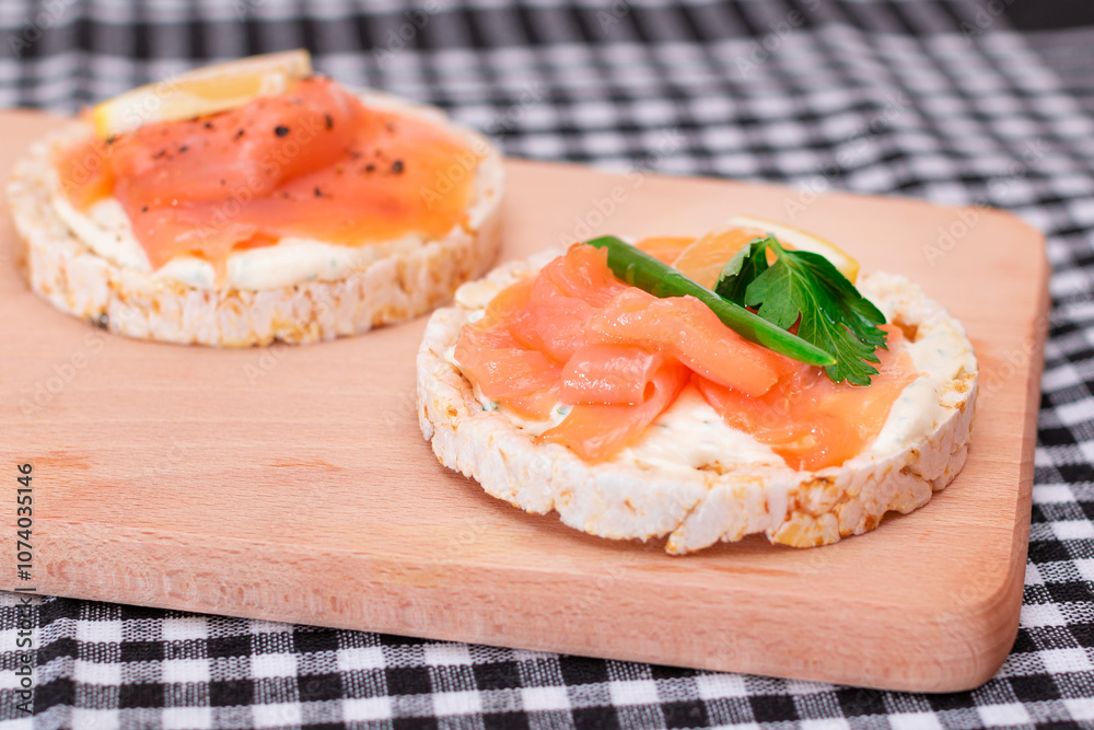 Rice Cake Sandwiches with Fresh Salmon, Cucumber, Lemon and Greens on Wooden Cutting Board. Diet Food. Quick and Healthy Sandwiches. Crispbread with Fresh Fillings. Healthy Dietary Snacks Rice Cake Sandwiches with Fresh Salmon, Cucumber, Lemon and Greens on Wooden Cutting Board. Diet Food. Quick and Healthy Sandwiches. Crispbread with Fresh Fillings. Healthy Dietary Snacks