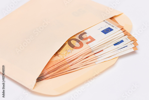 An Orange Paper Envelope with Stack of 50-Euro Banknotes Inside. Salary in Cash. Tax-Free System. Euro Currency. Payments with No Taxes. Orange Paper Money. A Lot of Fifty-Euro Bills
