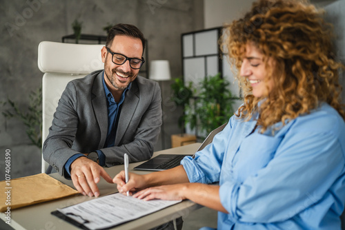 male colleague persuade a female colleague to signing a contract