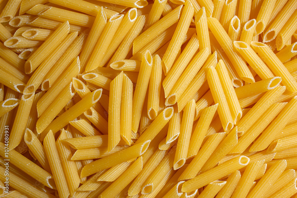 Uncooked Penne Rigate Pasta: A Culinary Canvas of Penne Macaroni, Creating a Lively and Textured Background for Gourmet Cooking. Dry Pasta. Raw Macaroni - Top View, Flat Lay Uncooked Penne Rigate Pasta: A Culinary Canvas of Penne Macaroni, Creating a Lively and Textured Background for Gourmet Cooking. Dry Pasta. Raw Macaroni - Top View, Flat Lay