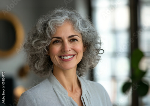 Female senior businesswoman with grey hair in office