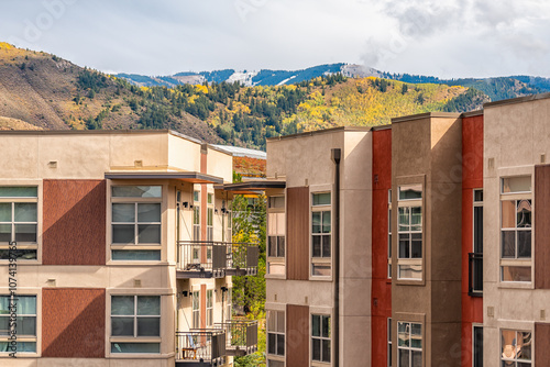 Avon, Colorado small town mountain Village in fall foliage with view of Rocky Mountains and modern apartment condo architecture by Vail