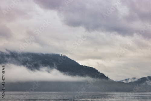 Landscape view of mountains and clouds over that lake in fall season. 