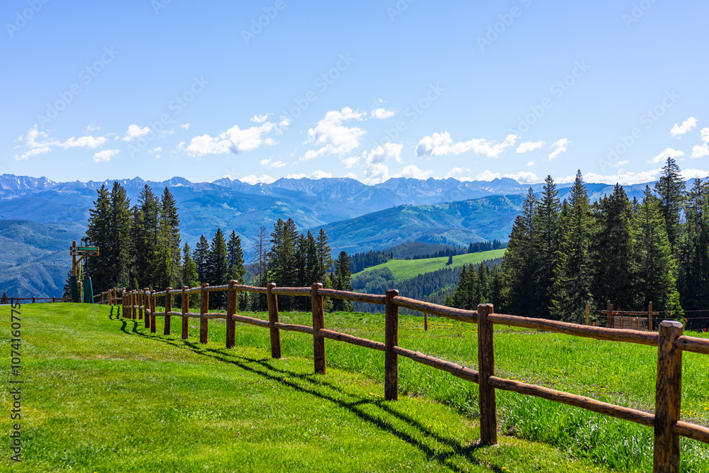 Beaver Creek village ski resort of Vail near Avon, Colorado in summer with wooden fence spruce fir trees forest and green meadow Beaver Creek village ski resort of Vail near Avon, Colorado in summer with wooden fence spruce fir trees forest and green meadow