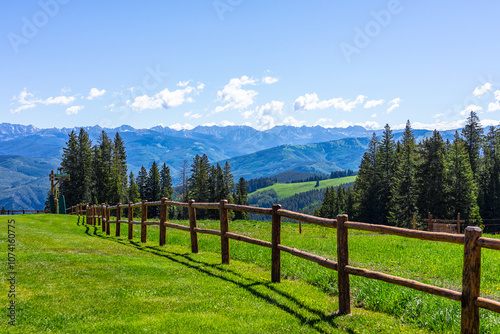 Fototapeta Naklejka Na Ścianę i Meble -  Beaver Creek village ski resort of Vail near Avon, Colorado in summer with wooden fence spruce fir trees forest and green meadow