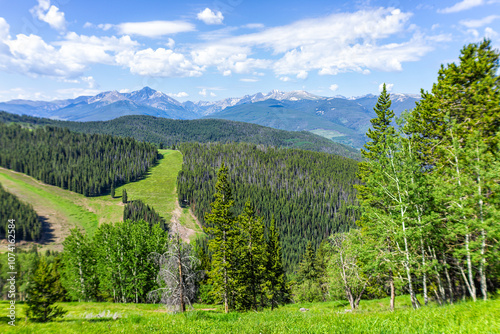 Vail summer in ski resort with hiking trail in Colorado with mountain peaks and mount of the holy cross in wilderness photo