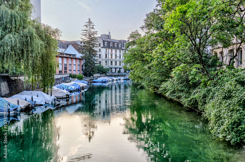 Fototapeta premium Zurich, Switzerland - July 26, 2024: Boats along the waterway of the Schanzengraben Promenade Zurich Switzerland 