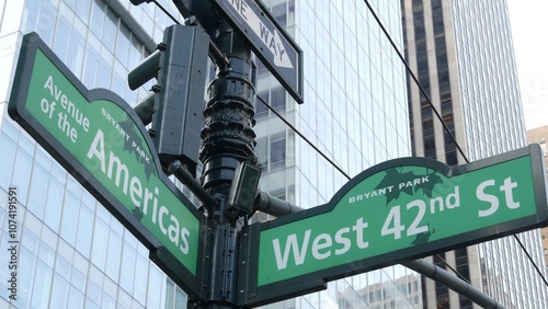 New York City crossroad, 42 street intersection road sign. 6 Sixth ave, Americas avenue corner, Midtown business district, NYC, Bryant park. Highrise skyscraper architecture, one way text roadsign. photo