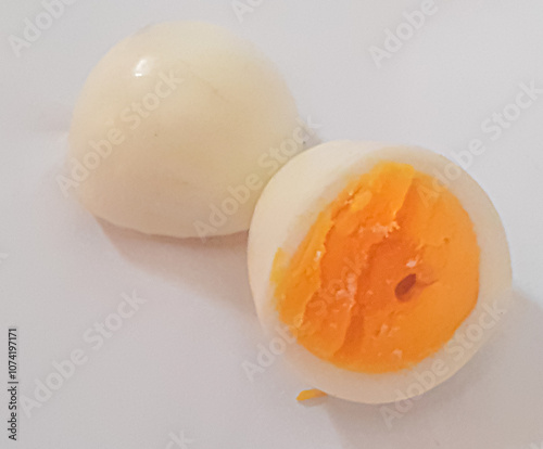 Broken and boiled chicken egg  slices on white background. Close-up view  photo