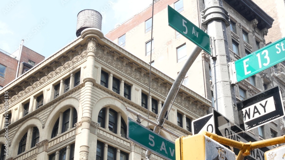 Fifth avenue 5 ave road sign, Manhattan midtown architecture, New York City 5th av street corner. Traffic crossroad signage, USA. Real estate in America, residential property. Rooftop water tower tank Fifth avenue 5 ave road sign, Manhattan midtown architecture, New York City 5th av street corner. Traffic crossroad signage, USA. Real estate in America, residential property. Rooftop water tower tank