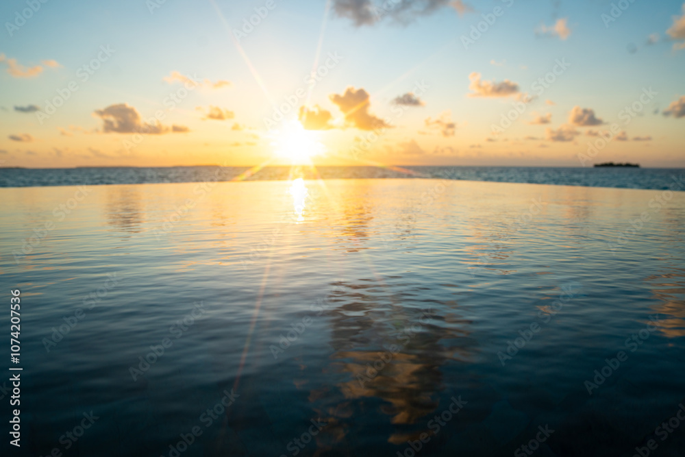 Naklejka premium Sunset views from overwater pool villa in Maldives