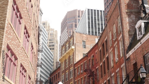 New York City classic building architecture. Residential house exterior. Real estate property in USA. Typical red brick facade. Manhattan downtown financial district, Stone street. Fire escape ladder.