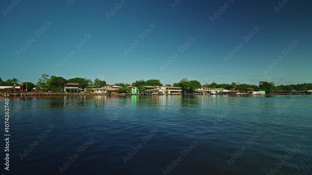 Navigating through the canals of Tortuguero National Park in Costa Rica. Panoramic view of the green lush vegetation and the rainforest. Natural reserve for wildlife and biodiversity. Navigating through the canals of Tortuguero National Park in Costa Rica. Panoramic view of the green lush vegetation and the rainforest. Natural reserve for wildlife and biodiversity.