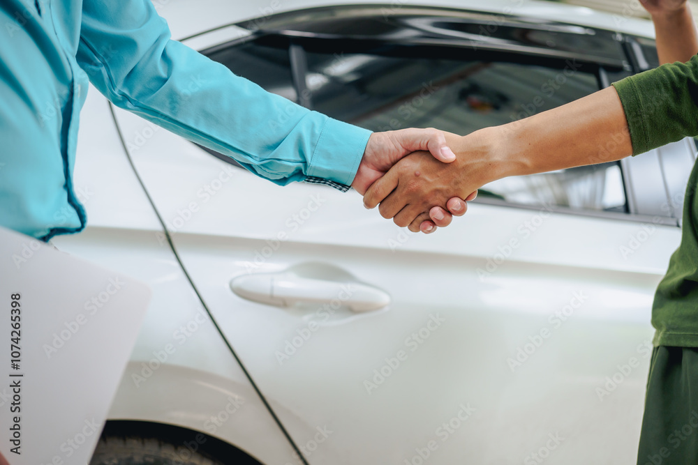 Asian clients engage with a car insurance agent beside a wrecked vehicle. They examine the policy details, assess the damage, and finalize paperwork related to the insurance claim and repairs. Asian clients engage with a car insurance agent beside a wrecked vehicle. They examine the policy details, assess the damage, and finalize paperwork related to the insurance claim and repairs.
