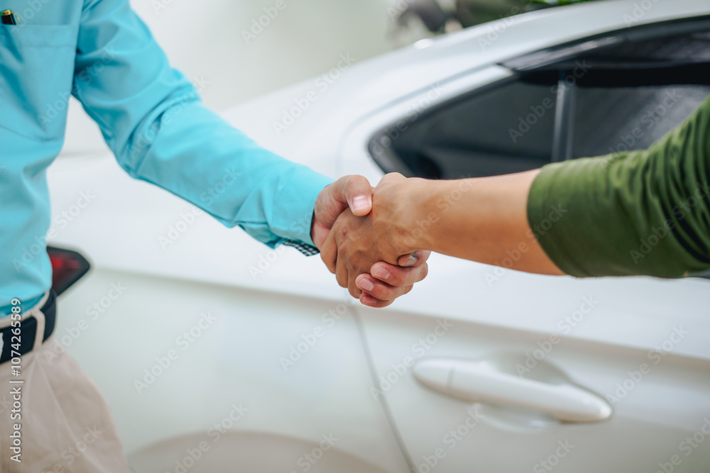 Asian clients engage with a car insurance agent beside a wrecked vehicle. They examine the policy details, assess the damage, and finalize paperwork related to the insurance claim and repairs. Asian clients engage with a car insurance agent beside a wrecked vehicle. They examine the policy details, assess the damage, and finalize paperwork related to the insurance claim and repairs.