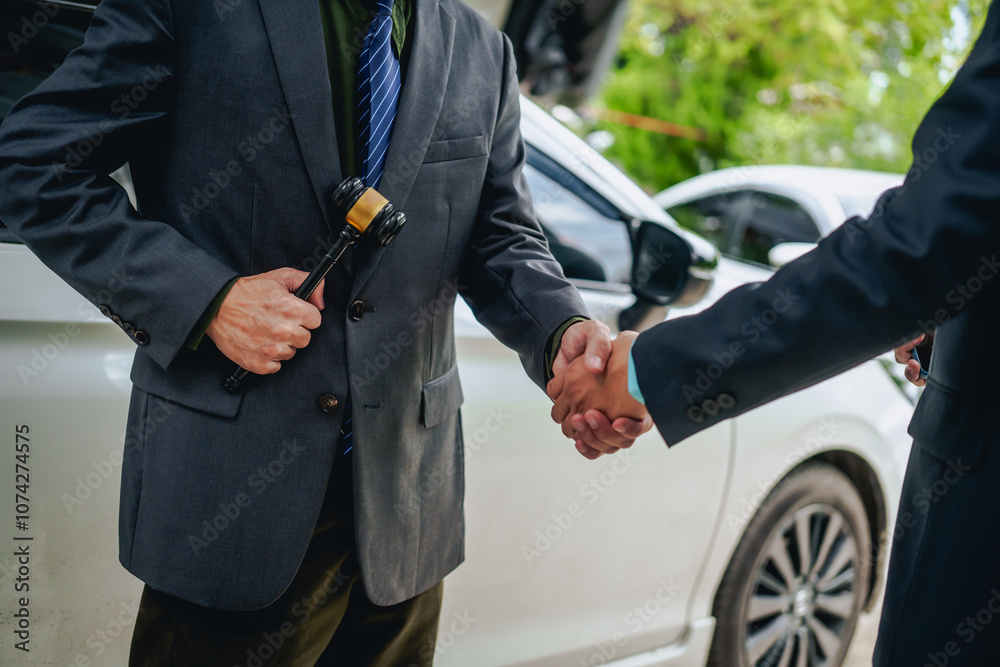 Obraz premium An Asian businessman buys a car, signs a contract with the salesman, and receives the keys. They discuss essential terms, covering car leasing, finance, and loan laws to finalize the purchase