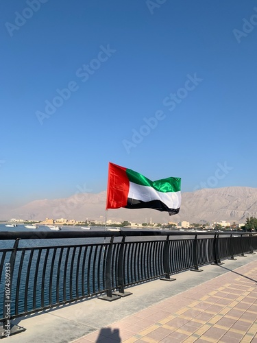 UAE flag against a backdrop of the northern Hajar mountains in preparation for National Day