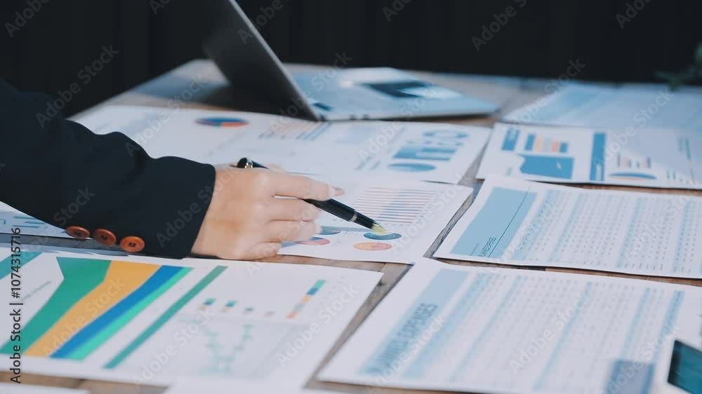 Group of confident business people point to graphs and charts to analyze market data, balance sheet, account, net profit to plan new sales strategies to increase production capacity. Group of confident business people point to graphs and charts to analyze market data, balance sheet, account, net profit to plan new sales strategies to increase production capacity.