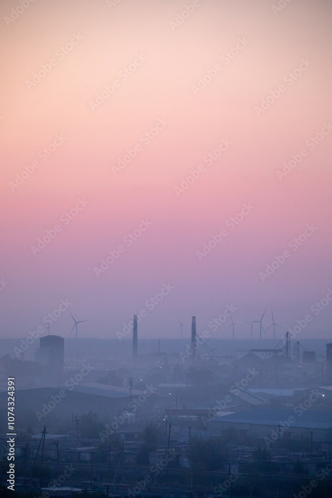 The Beautiful Wind Turbines Gracefully Silhouetted Against a Serene and Misty Sunset Sky The Beautiful Wind Turbines Gracefully Silhouetted Against a Serene and Misty Sunset Sky