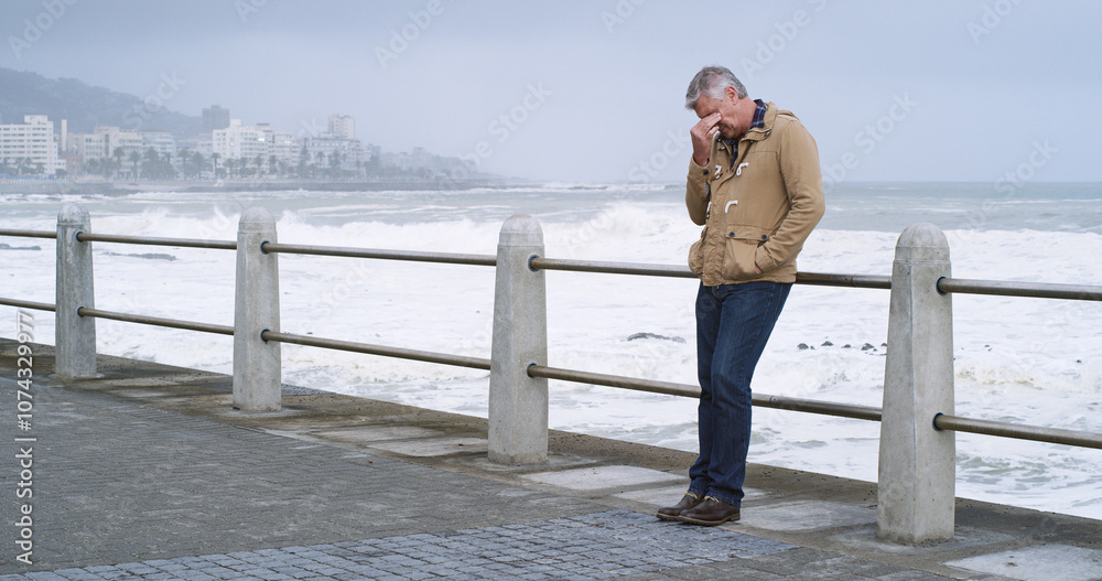 Senior man, thinking and sad by ocean promenade with headache, stress and reflection. Person, depression and insight for mistake, fog and decision with anxiety by sea, waves and outdoor in Italy Senior man, thinking and sad by ocean promenade with headache, stress and reflection. Person, depression and insight for mistake, fog and decision with anxiety by sea, waves and outdoor in Italy