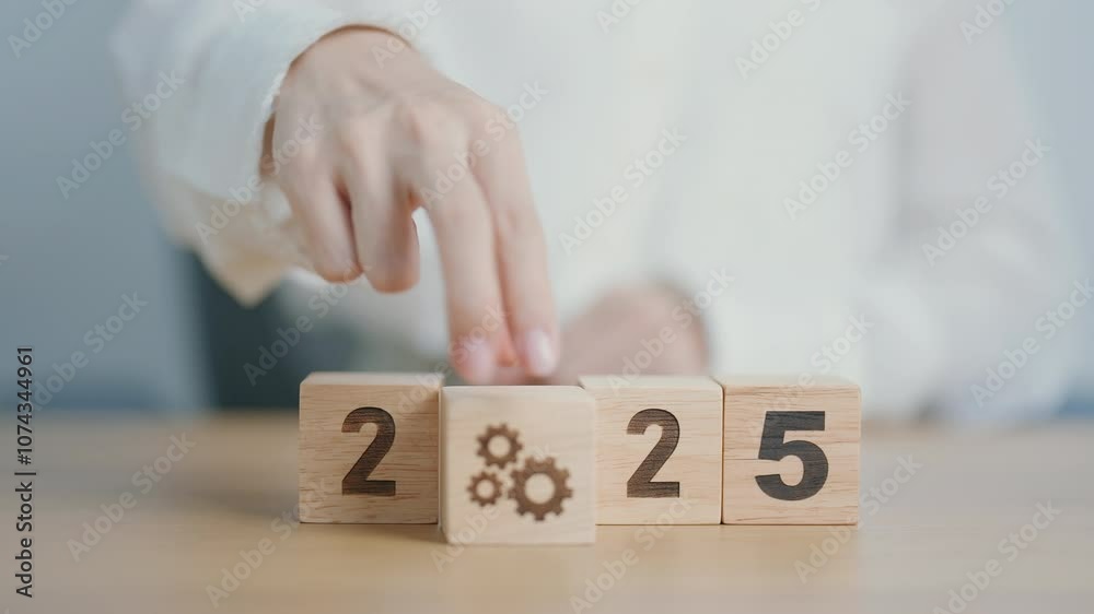 2025 year block with gear icon. Business Process, Team, teamwork, Goal, Target, Resolution, strategy, plan, Action, motivation, change, brainstorm and New Year start concepts 2025 year block with gear icon. Business Process, Team, teamwork, Goal, Target, Resolution, strategy, plan, Action, motivation, change, brainstorm and New Year start concepts