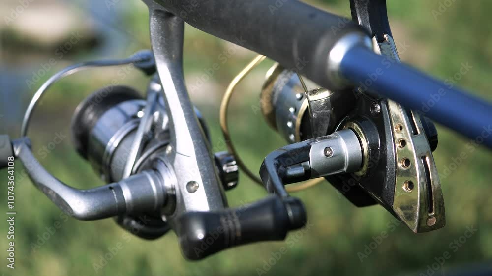 Spinning and spinning reels, fishing, outdoors, in the fresh air, on the river. Slow motion. Close-up. Spinning and spinning reels, fishing, outdoors, in the fresh air, on the river. Slow motion. Close-up.