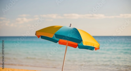 Colorful beach umbrella beside clear blue waters and sandy shores during daytime. photo