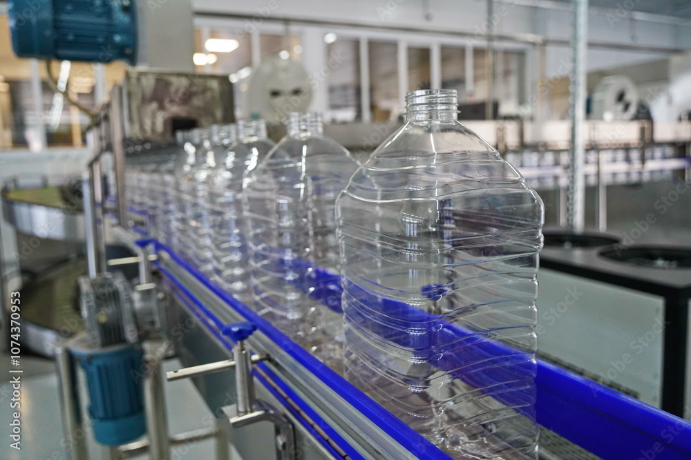 Plastic bottles on a conveyor belt at the factory. Plastic bottles on a conveyor belt at the factory.