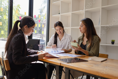 Asian businesswoman teamwork working on laptop with finances analysis report at desk in office, business financing, accounting banking, Team of creative and business planning, 