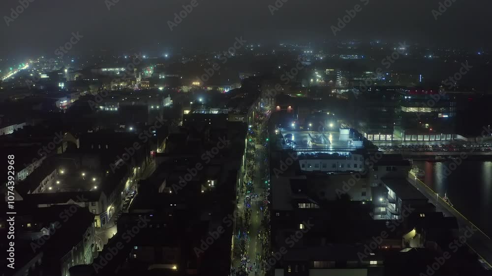 Bird's-eye view of Galway's Halloween night parade under dense fog Bird's-eye view of Galway's Halloween night parade under dense fog