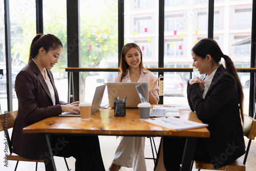 Technology and financial advisory services concept. Businesswoman teamwork and working on digital laptop computer with advisor showing plan of investment to clients at table office. Digital marketing.