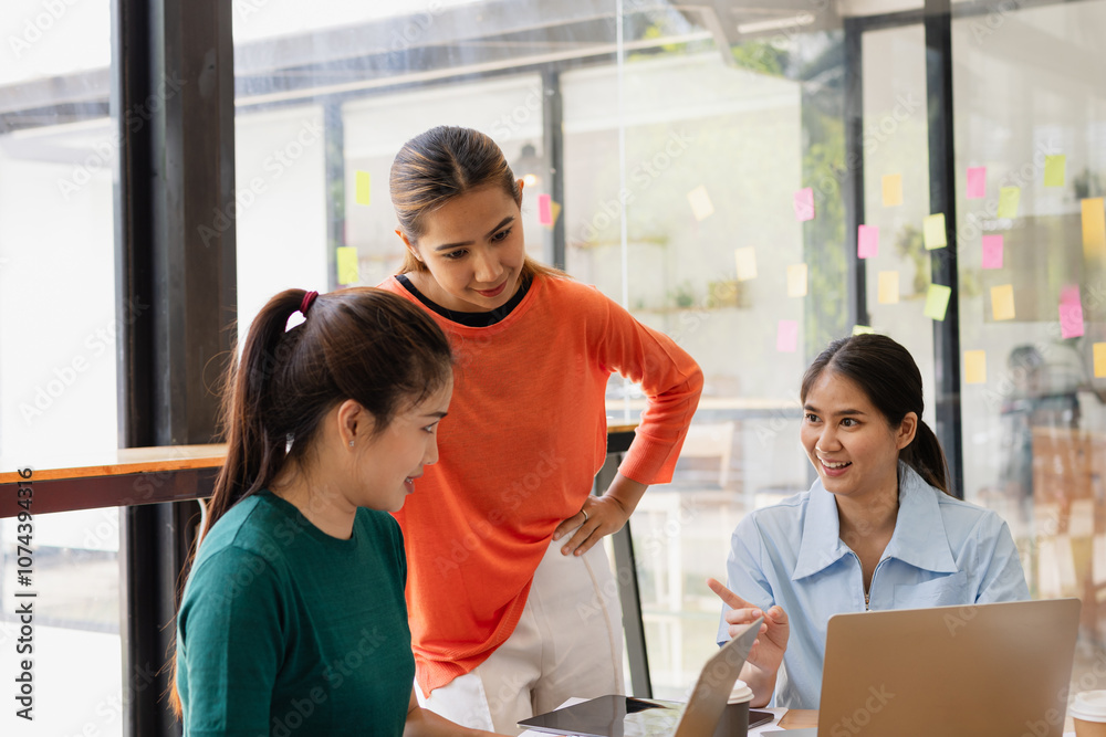 Fototapeta premium Excited Asian businesswoman team working together in office, About successful startup projects concept.