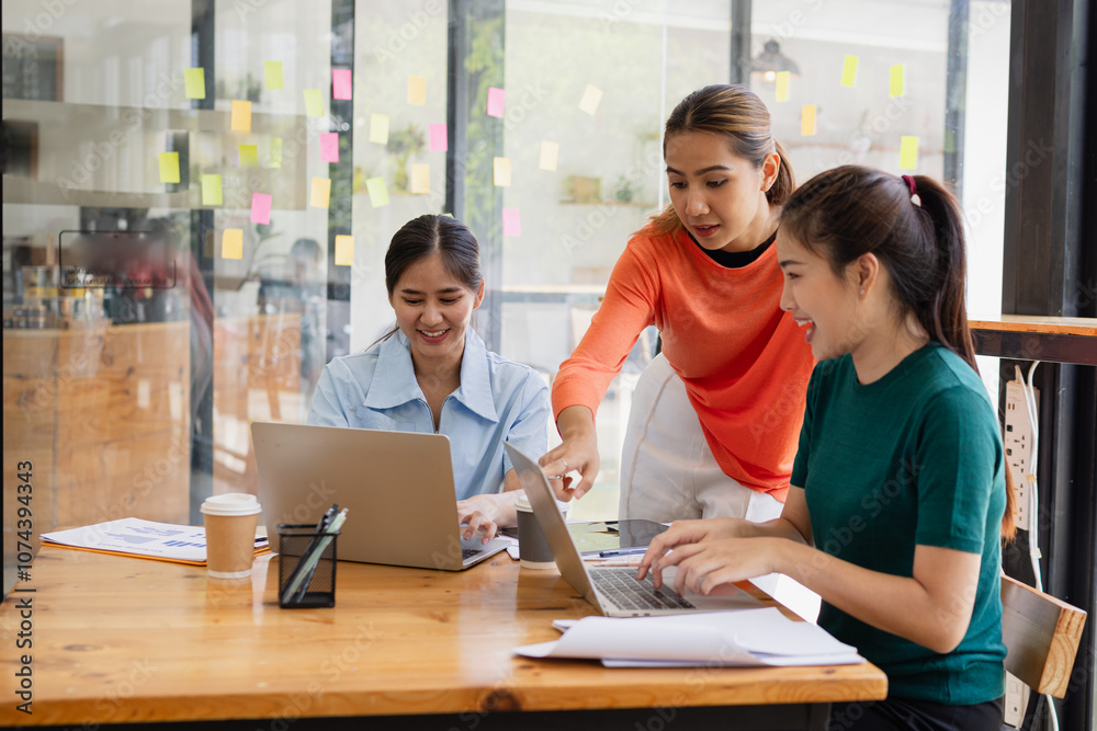 Excited Asian businesswoman team working together in office, About successful startup projects concept. Excited Asian businesswoman team working together in office, About successful startup projects concept.