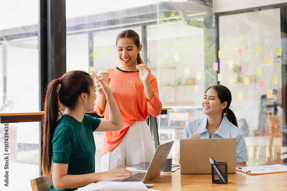 Fototapeta premium Excited Asian businesswoman team working together in office, About successful startup projects concept.