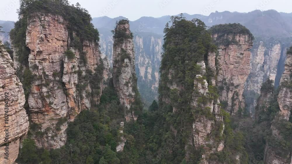 A dynamic, fast-paced drone flyover capturing the majestic rock pillars of Zhangjiajie, China, offering a thrilling aerial perspective of this iconic landscape A dynamic, fast-paced drone flyover capturing the majestic rock pillars of Zhangjiajie, China, offering a thrilling aerial perspective of this iconic landscape