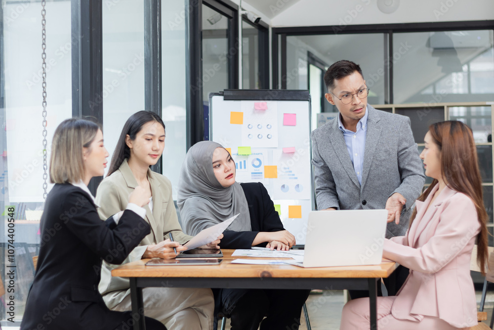 Team of Asian business people and working together in office, Startup projects and business presentation at meeting room. Team of Asian business people and working together in office, Startup projects and business presentation at meeting room.
