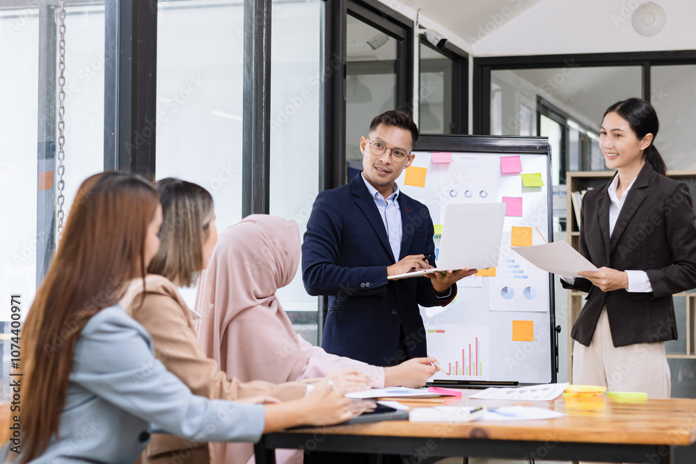 Team of Asian business people and working together in office, Startup projects and business presentation at meeting room. Team of Asian business people and working together in office, Startup projects and business presentation at meeting room.